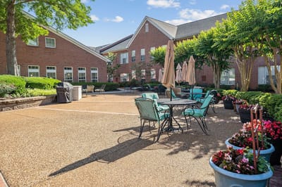 Outdoor patio area with seating and greenery