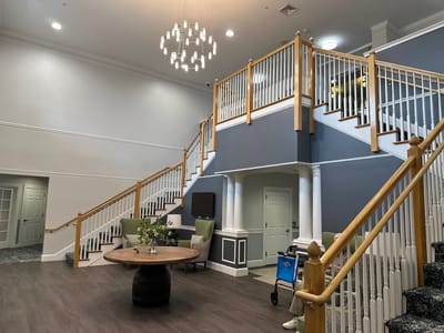 Bright lobby area with seating and staircase