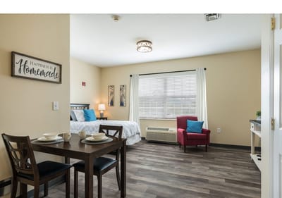 A cozy private resident room with dining table and decor