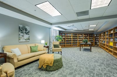 Interior view of a cozy library area with seating and bookshelves