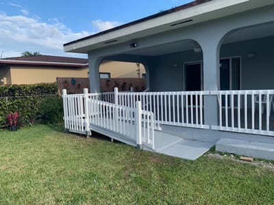 Accessible outdoor ramp leading to a covered porch area