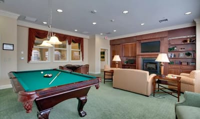 Common area with a pool table and seating.