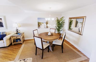 Bright dining area with a round table and four chairs