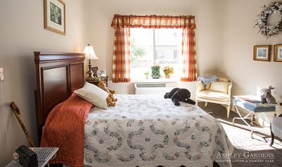 A cozy resident room with a bed and window