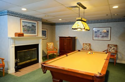 Interior room with a pool table and decorative lighting
