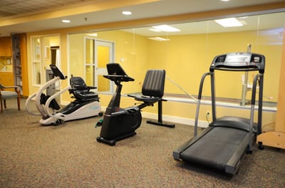 Fitness equipment in a well-lit exercise room