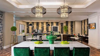 Bright dining room with green accents and food display