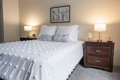 Cozy bedroom setup with decorative pillows and lamps