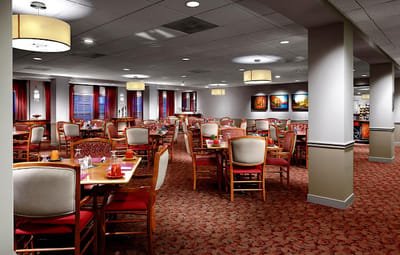 Bright dining room with tables and chairs set up