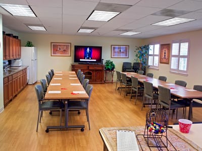 Bright activity room with tables and chairs