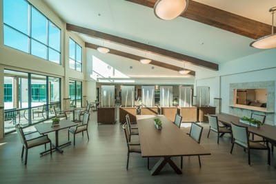 Bright dining area with large windows and modern furniture