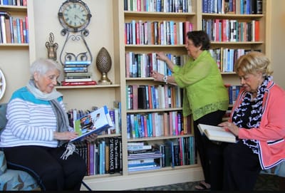 Residents enjoying books in a cozy library area