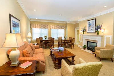 Bright common area with comfortable seating and dining tables
