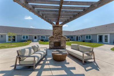 Outdoor seating area with a fireplace and courtyard view