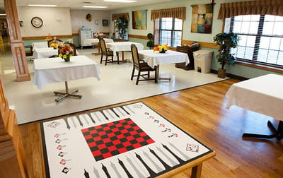 Bright common area with tables and checkerboard design
