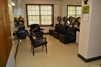 Interior photo of a hair salon area with styling chairs