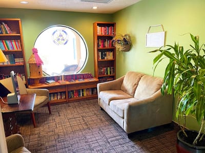 Cozy reading nook in a common area with bookshelves