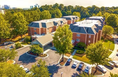 Aerial view of Dunwoody Place facility surrounded by trees