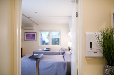 View of a resident room with beds and light.