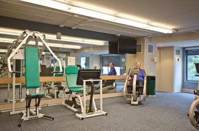 A resident exercising in a fitness room