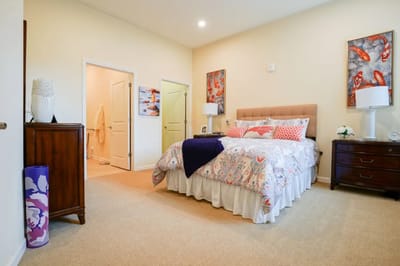 A well-decorated private resident room with a bed