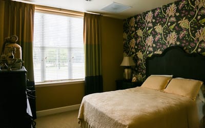 Cozy private resident room with floral wallpaper