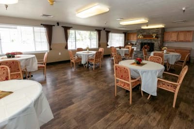 Bright dining room with tables and chairs set for meals