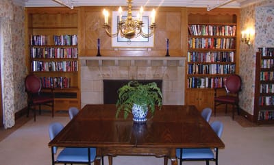 Cozy common area with bookshelves and a dining table