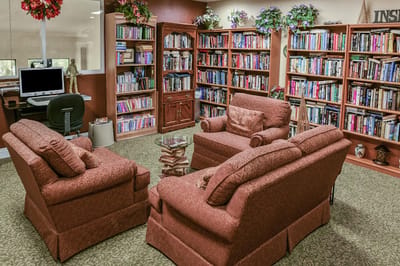 Cozy library reading area with bookshelves and seating