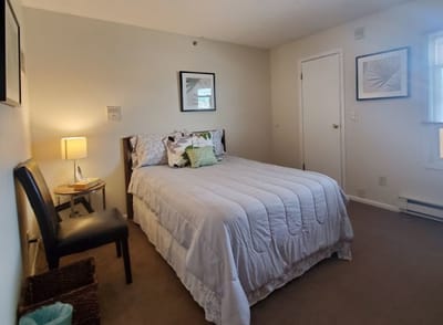 Cozy private resident room with bed and chair