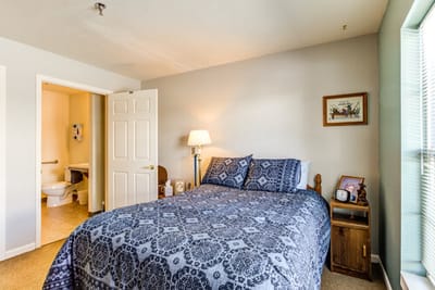 Cozy private resident room with a bed and lamp