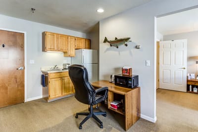 Cozy interior of a resident room with desk and kitchenette