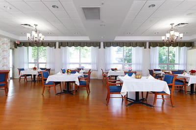 Bright dining room with tables set for meals