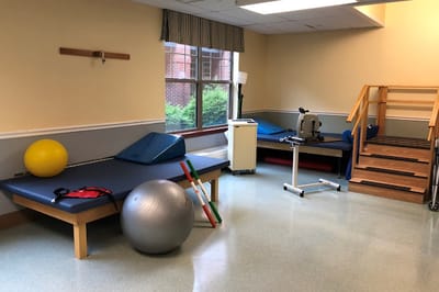 Rehabilitation room with exercise equipment and mats