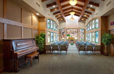 Bright common area with windowed walls and seating