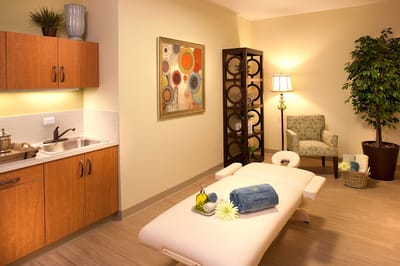 A tranquil therapy room with a massage table and decor