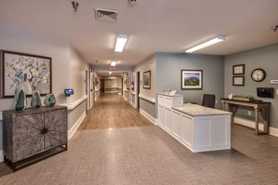 Bright lobby area with reception desk and artwork