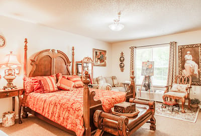 Cozy resident room with a decorative bed and sitting area