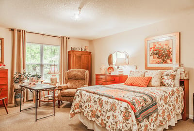 Cozy resident room with floral decor and furniture