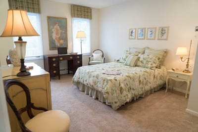 Cozy resident room with floral decor and a bed