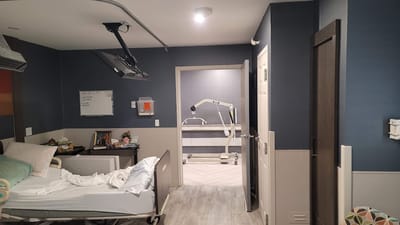 Interior view of a resident room with hospital bed