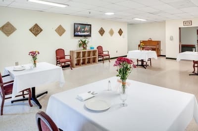 Dining room with set tables and flowers