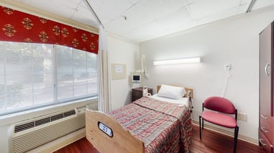 Private resident room with bed and chair