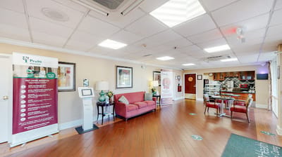 Interior view of a common area with seating and signage