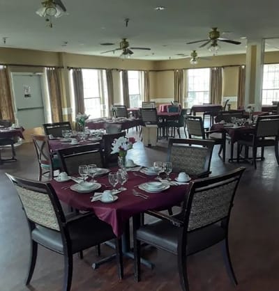 Dining room set up for a meal with table settings