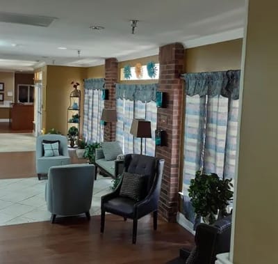 Interior common sitting area with seating and windows