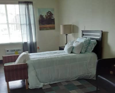 Cozy resident room with a bed and seating area