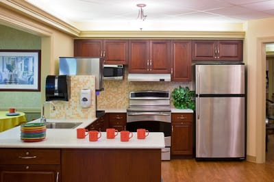Bright interior kitchen area with cabinets and appliances