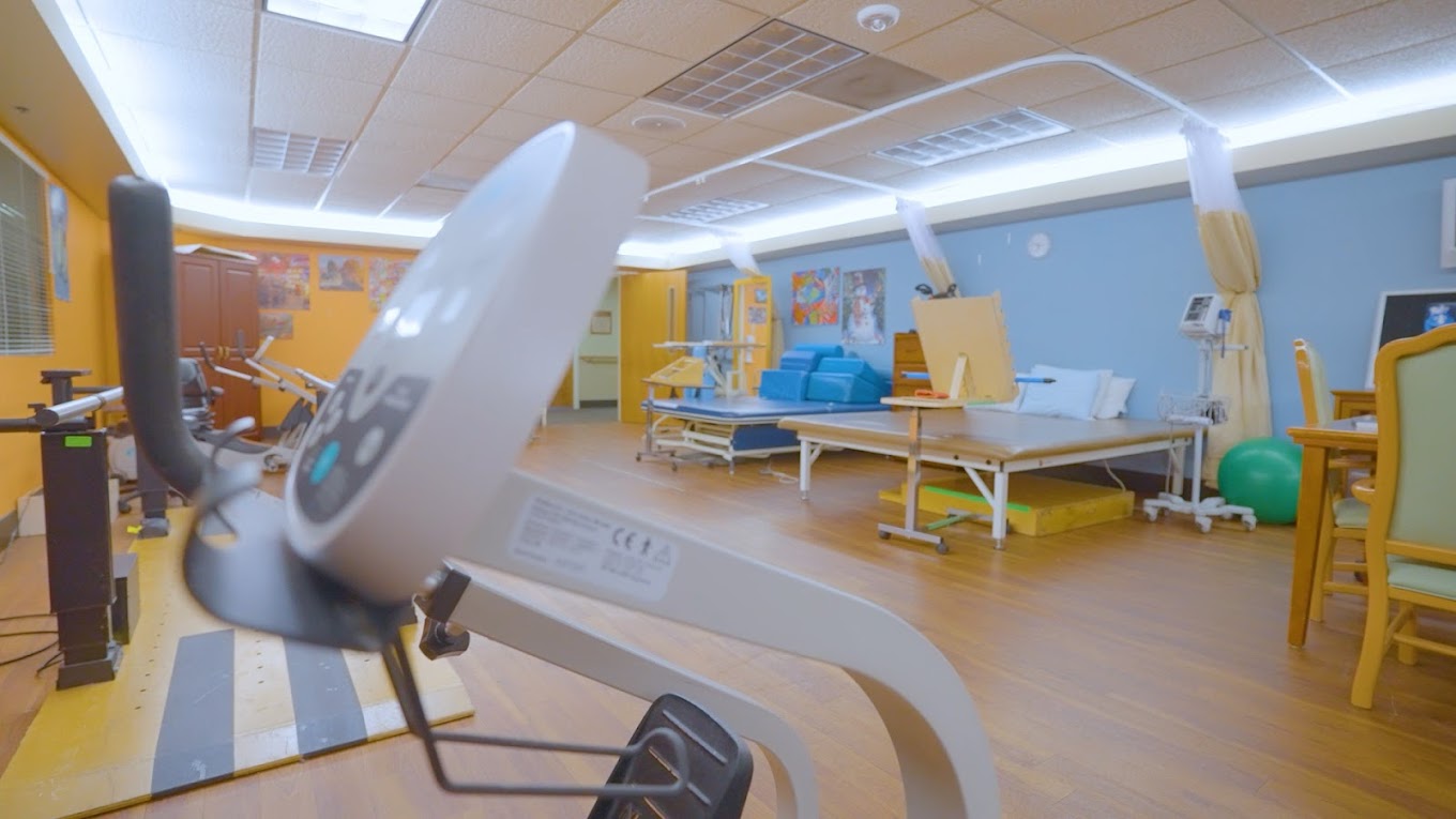 Rehabilitation room with exercise equipment and therapy beds