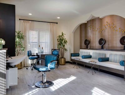 A bright hair salon area with modern chairs